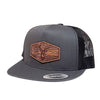 Gray trucker cap with a brown leather patch featuring a deer design on a white background.
